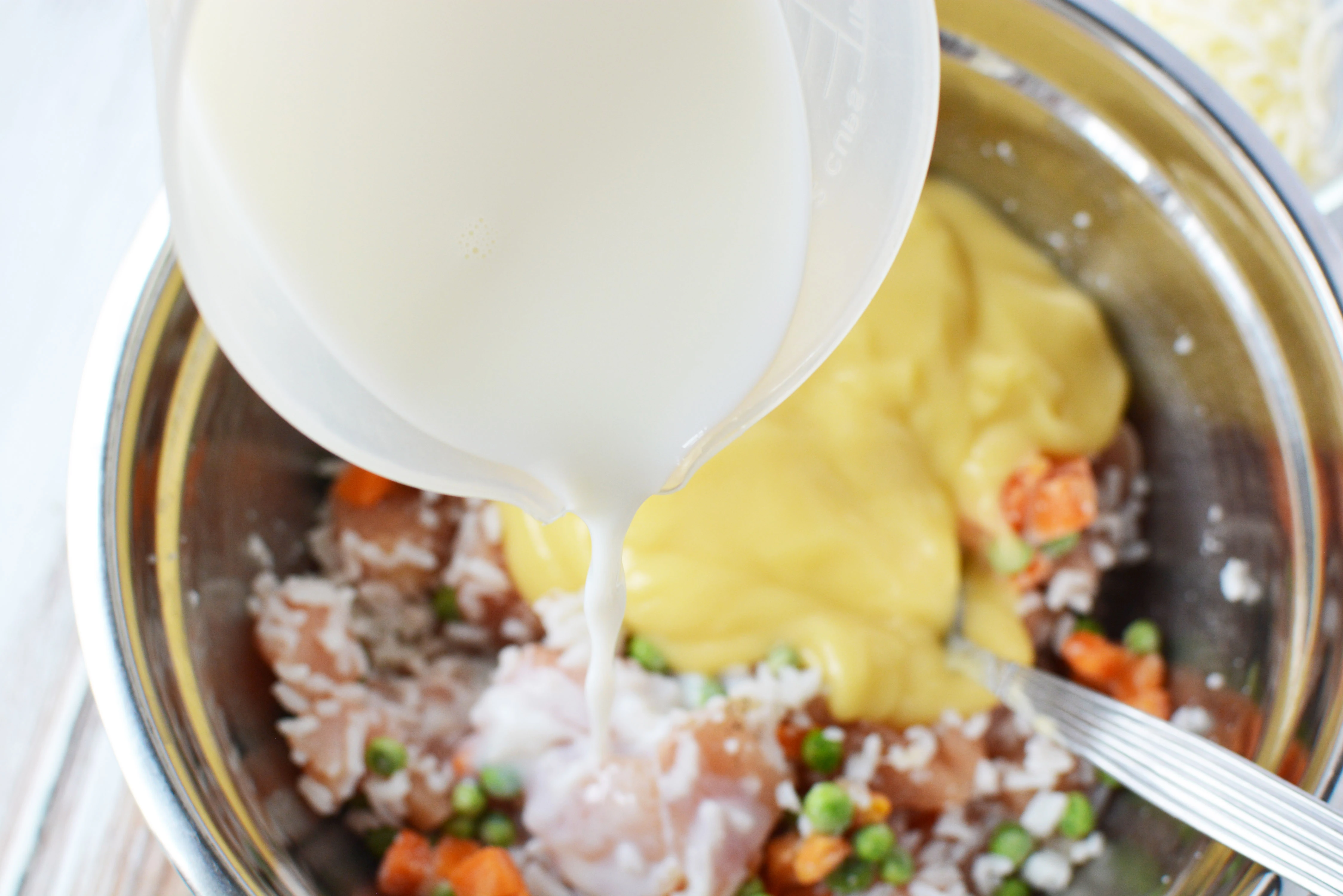 Add the milk, soup and cheese into the bowl.