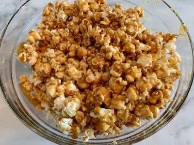 Coating the popcorn with caramel mixture