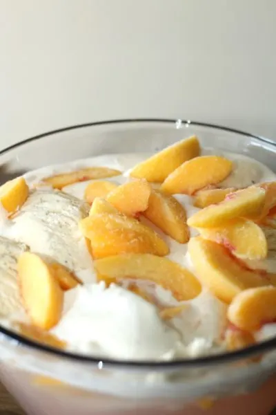 Adding floating peaches on top of drink