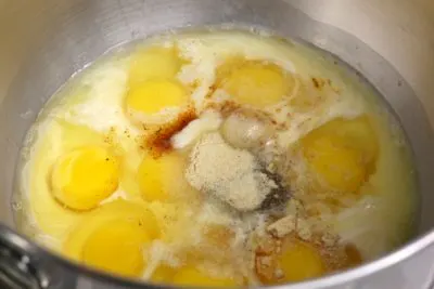 Whisking together the large eggs in a mixing bowl with spices.