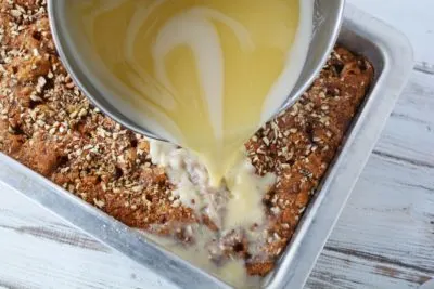 Pouring hot glaze over cake. Pouring hot glaze over cake.