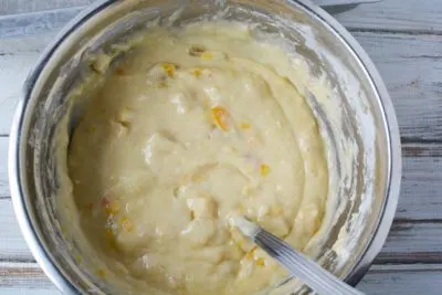 Mixing fruit cocktail cake batter in bowl. Mixing fruit cocktail cake batter in bowl.