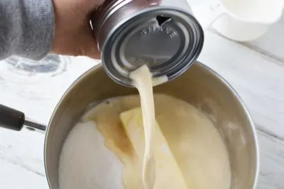 Adding evaporated milk to create glaze topping. Adding evaporated milk to create glaze topping.