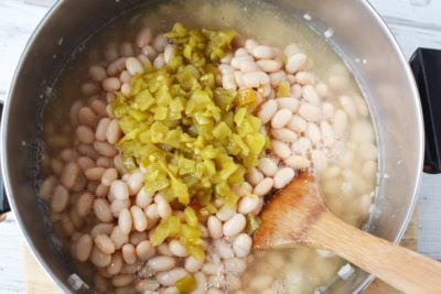 Add the green chilies and the chicken broth