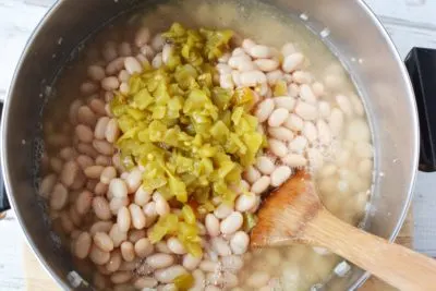 Add the green chilies and the chicken broth