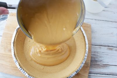 Pouring Peanut Butter Filling Into Pie Crust
