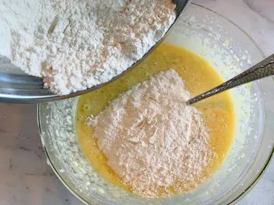 Adding flour mixture the cake