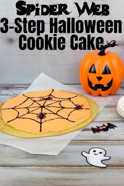 This EASY 3-step Halloween Cookie Cake is fun and festive. Just press the store-bought dough, bake and decorate. It's perfect for a Halloween party too! #HalloweenParty #HalloweenCake #HalloweenRecipe #SpiderWebCake #CookieCake 