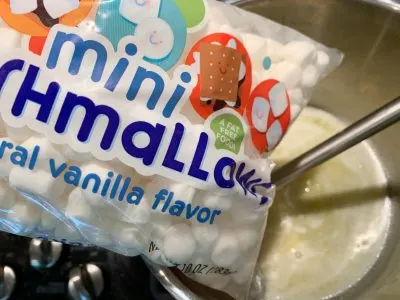 Adding mini marshmallows into the pot Adding mini marshmallows into the pot