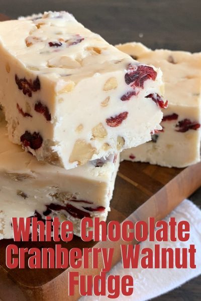 This White Chocolate Cranberry Walnut Fudge recipe is so festive! It's speckled with dried cranberries and chopped walnuts. Make a batch to give away and freeze the rest. #Fudge #HomemadeFudge #ChristmasCandy #ChristmasFudge #CranberryRecipe #HomemadeHolidayGift