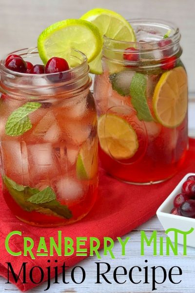This festive Cranberry Mojito recipe is the perfect Christmas cocktail! It's muddled mint, cranberries, light rum, sugar and soda water with lime. The red and green coloring makes it perfect for the holiday season. #CranberryRecipe #CranberryCocktail #Mojito #ChristmasCocktail #ChristmasCocktailRecipes