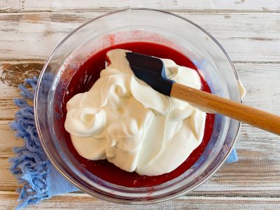 Folding in the whipped cream to the Cranberry