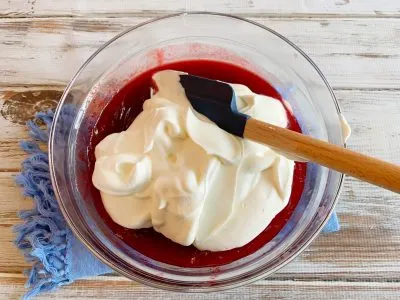 Folding in the whipped cream to the Cranberry