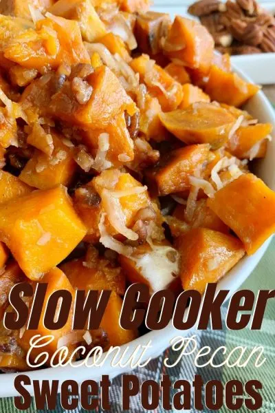 Keep Thanksgiving easy with these Slow Cooker Sweet Potatoes. They've got chopped pecans, coconut and marshmallow for the ultimate side dish recipe. #Thanksgiving #ThanksgivingRecipe #ThanksgivingSideDish #SweetPotatoes #SweetPotatoesRecipe