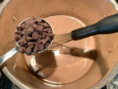 Adding chocolate to steamed milk