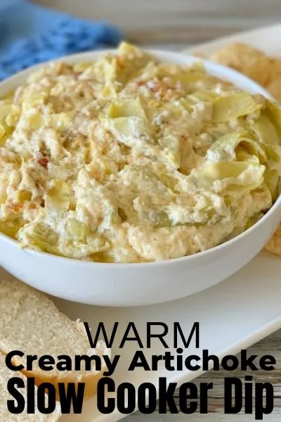 The ultimate warm dip, everyone loves this Creamy Artichoke Slow Cooker Dip recipe. It's the perfect hot appetizer for any occasion. #SlowCooker #HotDip #DipRecipe #ArtichokeDip #SlowCookerDip