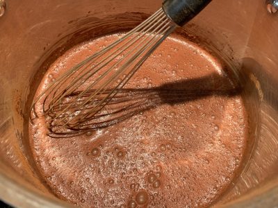 Whisking hot chocolate until clumps are gone