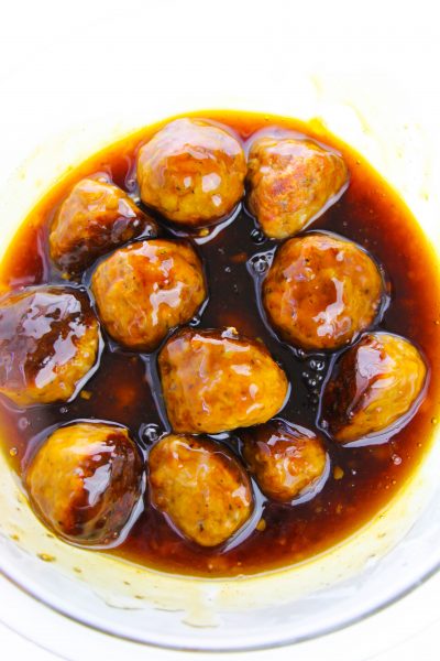 Coating meatballs in asian glaze sauce