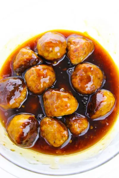 Coating meatballs in asian glaze sauce