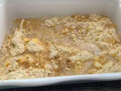 Butter poured over peach dump cake