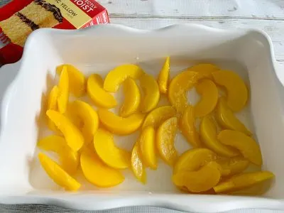 Peaches with syrup in baking dish