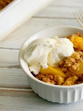 Serving peach dump cake with ice cream