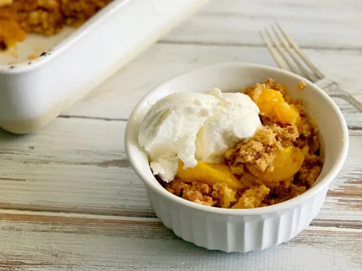Serving peach dump cake with ice cream