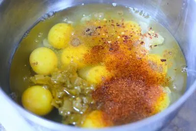 Mixing eggs and green peppers in bowl