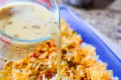 Pouring Egg Mixture Over The Christmas Egg Casserole
