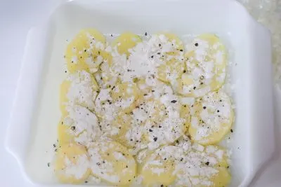 Layering potatoes in casserole dish Layering potatoes in casserole dish