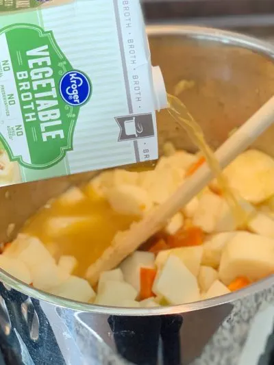 Adding vegetable broth to soup