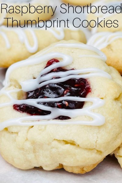 A classic Christmas cookie, these Raspberry Shortbread Thumbprint Cookies have a buttery soft base, raspberry preserve filling and finished with a sweet icing. 