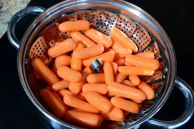 steaming baby carrots in steamer