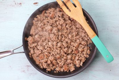 Browning off breakfast sausage in a medium skillet over stovetop 