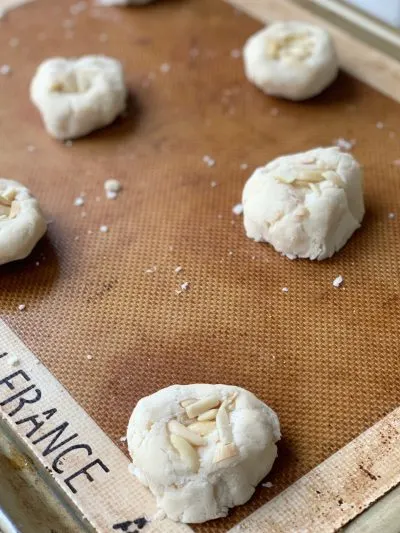 Rolling Chinese Almond Cookies into Ball and pressing almonds