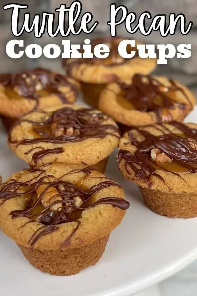 With a soft and chewy bottom, these Turtle Pecan Cookie Cups are topped with melted chocolate, caramel and pecan bits.