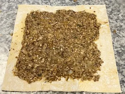 Folding puff pastry with mushroom stuffing