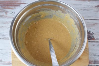 Mixing wet and dry ingredients together to create a batter
