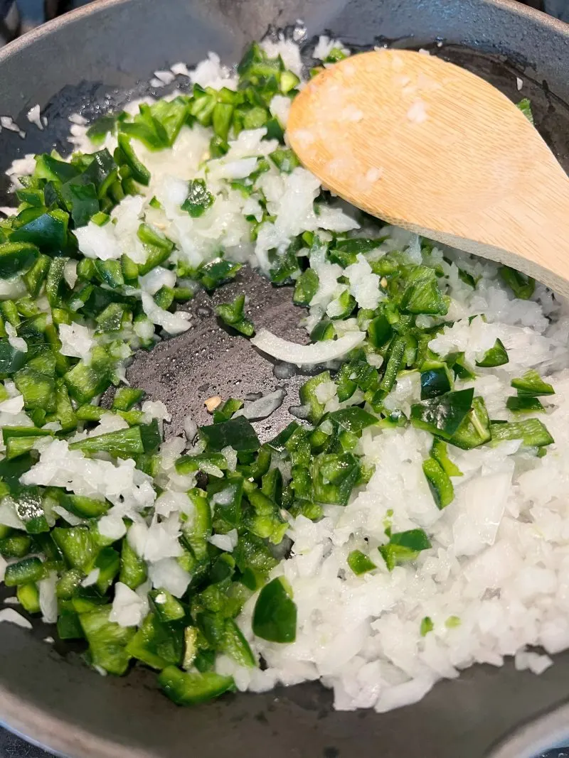 Saute onion and poblano pepper together in pan