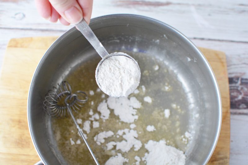 Adding flour to melted butter