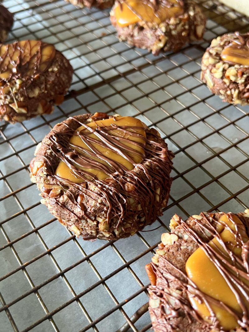 Adding chocolate drizzle over the top of each cookie