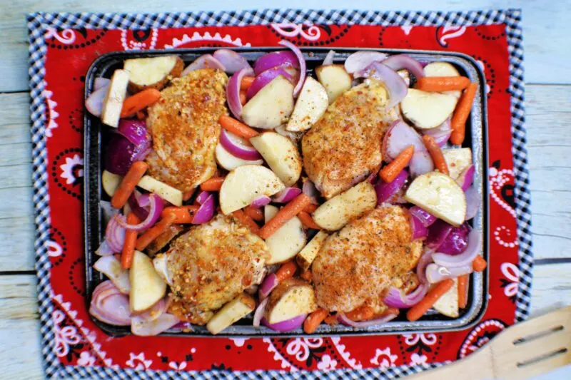 Adding chicken thighs to the vegetables