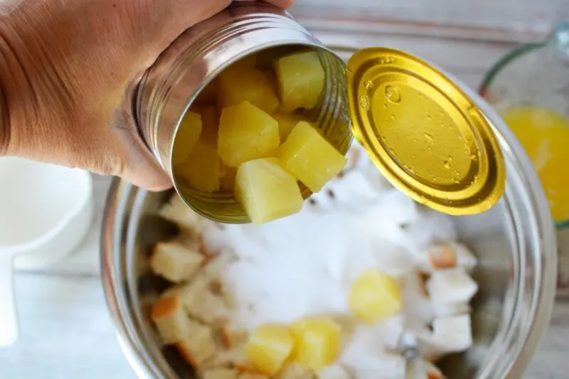 Adding pineapple chunks into the mixture