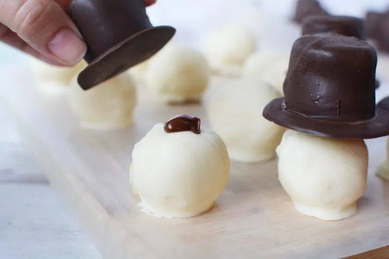 Attaching hat with melted chocolate 