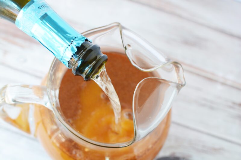 Pouring Prosecco into the Thanksgiving punch