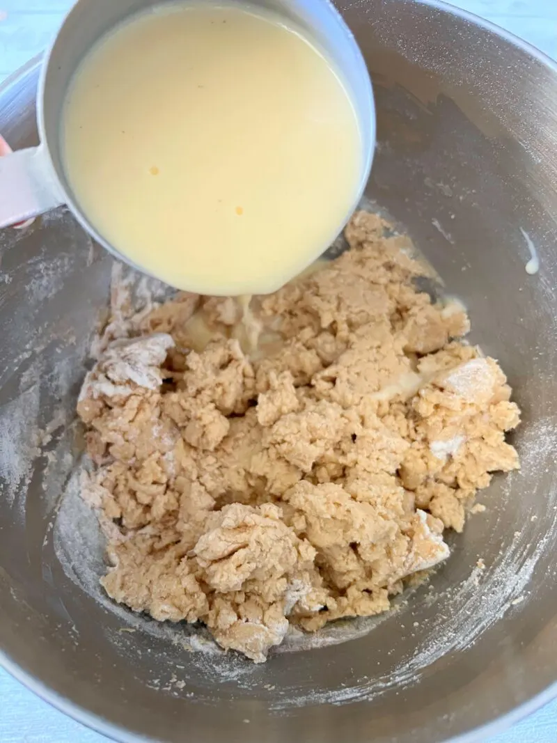 Slowly add eggnog into cake batter