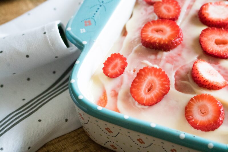 Adding the layer of fresh strawberries on top