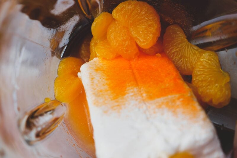 Mixing together the oranges, cream cheese and vodka in a blender