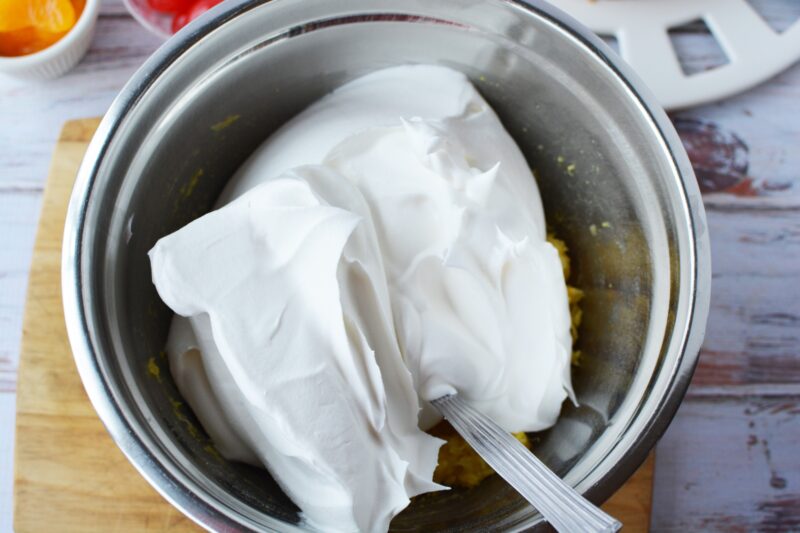 Folding Cool Whip into pineapple mixture
