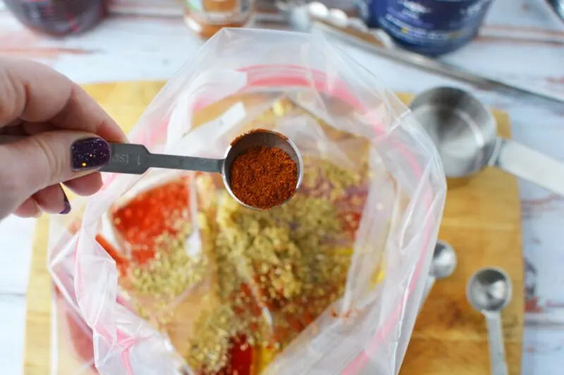 Adding spices to the Mexican Chicken Marinade.